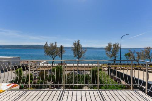 a view of the ocean from a balcony of a building at Villa Fontana in Starigrad-Paklenica