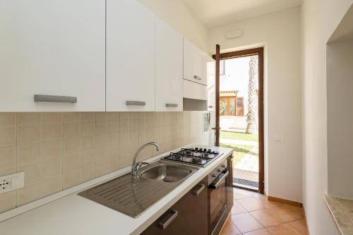 a kitchen with a sink and a stove at Resort Santa Maria Hotel in Birgi Vecchi