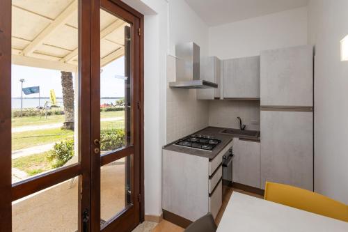 a kitchen with a stove top oven next to a window at Resort Santa Maria Hotel in Birgi Vecchi