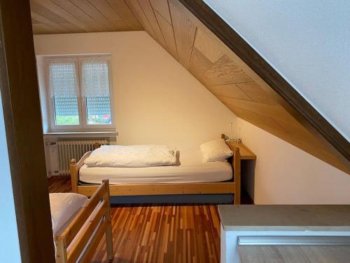 a bedroom with a bed in a attic at Sonnenschein Chalet in Buxheim