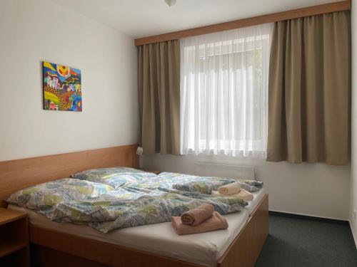 a bedroom with a bed with two pillows on it at Apartmán PalacKY in Kyjov
