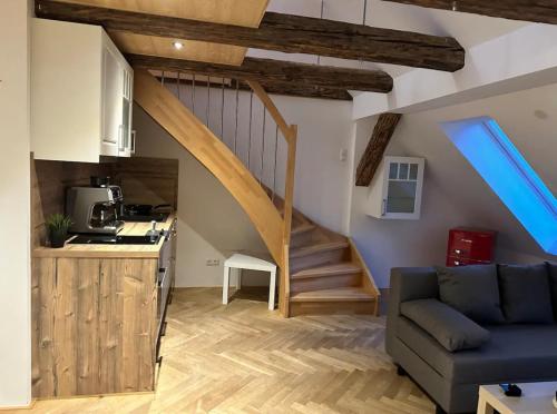 a kitchen and a living room with a staircase at Exklusive Maisonetten Wohnung 2.OG in Augsburg