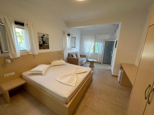 a bedroom with a large bed and a living room at Dima Vista in Dhërmi