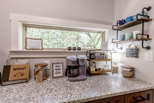 a kitchen counter with a coffee maker on a counter top at Hemlock Hideaway in Ellijay
