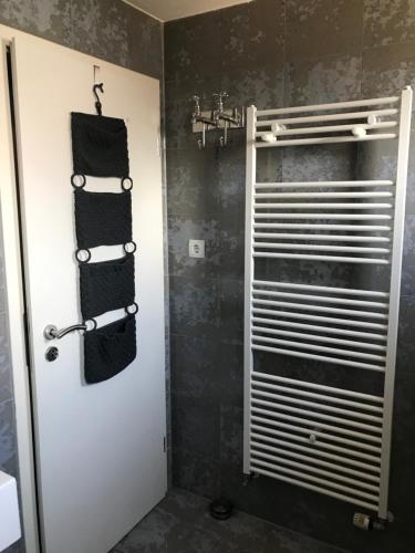 a bathroom with a towel rack and a shower at Gästehaus Nicole in Burgau