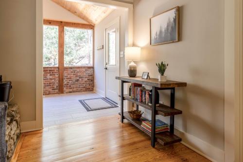 a living room with a book shelf and a door at Hemlock Hideaway in Ellijay