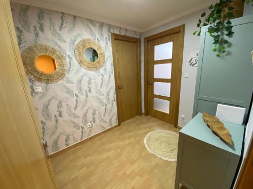 a room with a hallway with a wall with a floral wallpaper at APARTAMENTO CASA PLAYA in Boiro