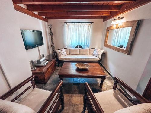 a living room with a couch and a table at Castaway's View Villa in Avlákia
