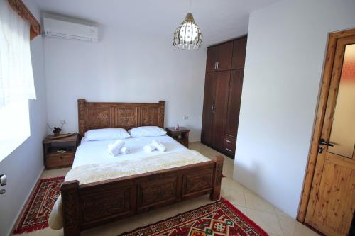 a bedroom with a bed with two pillows on it at Guri Guesthouse in Gjirokastër