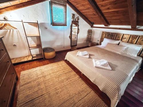a bedroom with a large bed with two towels on it at Castaway's View Villa in Avlákia