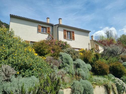 a house on top of a hill with plants at Côté Lac Tolla in Tolla