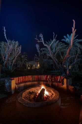 a fire pit in a yard at night at Olive Garden House Siwa in Siwa