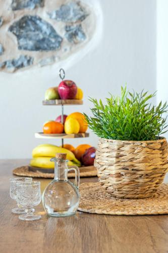 a table with a vase and a basket of fruit at Terra Creta Hideaway in Heraklio Town