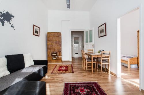 a living room with a couch and a table at Comfortable flat with prime location near Oktogon in Budapest