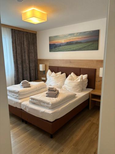 a hotel room with two beds with towels on them at Apartment 111 in Feldberg