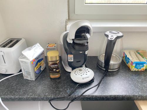 a kitchen counter with a mixer and other kitchen items at Apartment nähe Linz in Puchenau