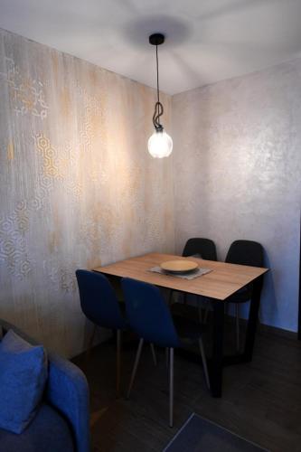 a dining room table with chairs and a light fixture at Villa Luxury Medjuvrsje in Međuvršje