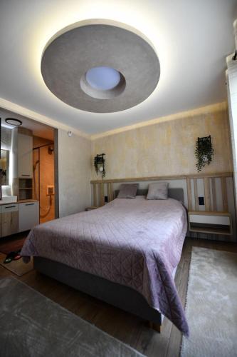 a bedroom with a large bed with a large ceiling at Villa Luxury Medjuvrsje in Međuvršje