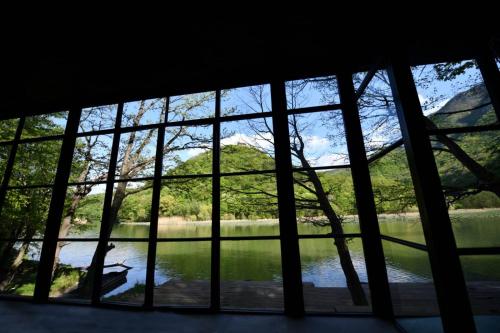 a view of a lake through a window at Villa Luxury Medjuvrsje in Međuvršje