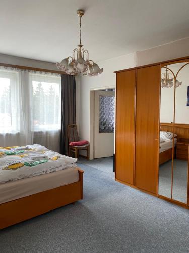 a bedroom with a bed and a large wooden cabinet at Appartment nähe Linz in Puchenau