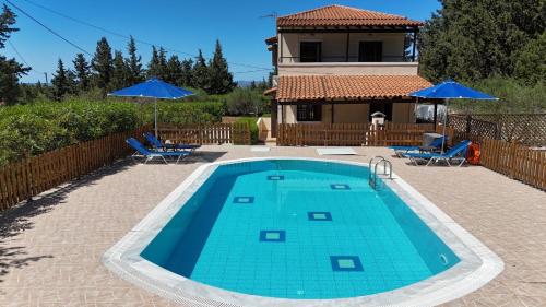 a swimming pool in front of a house at Villa Oleander in Chania Town