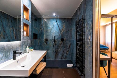 a bathroom with a sink and a shower at Hotel Touring in Bologna