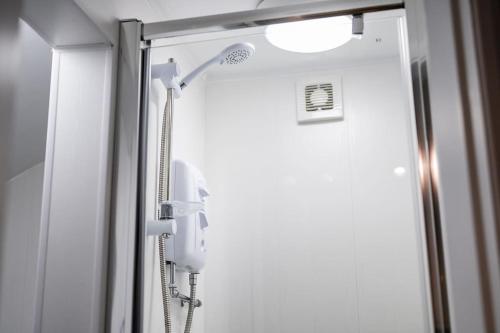 a shower with a phone in a bathroom at Fisherman's Rest in Cleethorpes