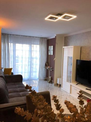 a living room with a couch and a television at Unique Apartment La Pineda in La Pineda