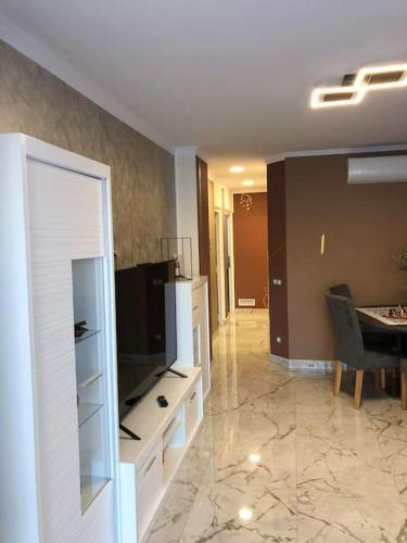 a living room with a television and a dining room at Unique Apartment La Pineda in La Pineda