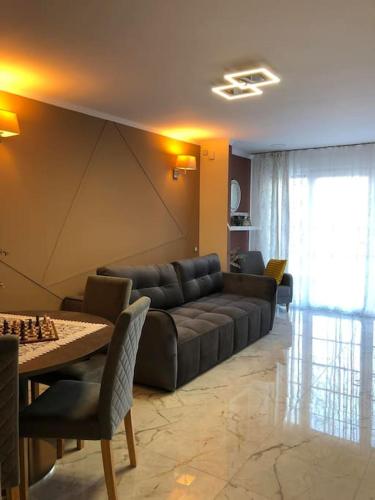 a living room with a couch and a table with chess at Unique Apartment La Pineda in La Pineda