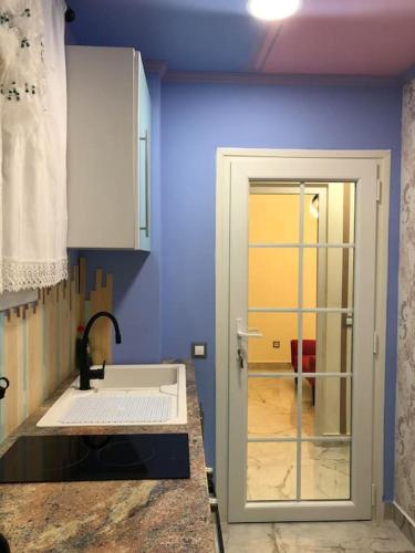 a kitchen with a sink and a blue wall at Unique Apartment La Pineda in La Pineda