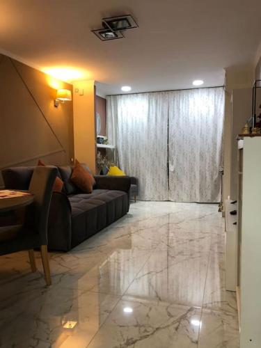 a living room with a couch and a table at Unique Apartment La Pineda in La Pineda
