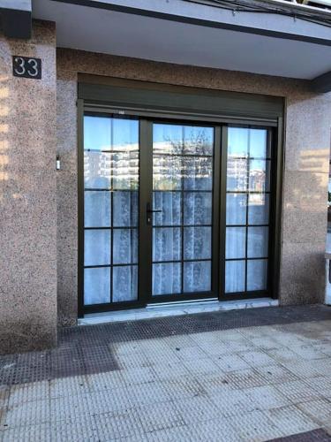 a large glass door of a building with a window at Unique Apartment La Pineda in La Pineda