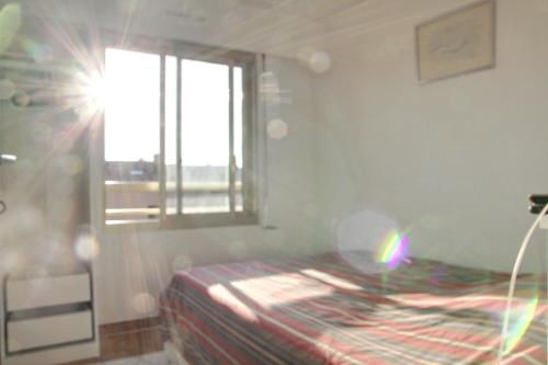 une petite chambre avec un lit et une fenêtre dans l'établissement PIN ROLLAND, à Saint-Mandrier-sur-Mer