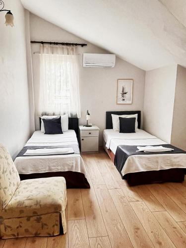 a bedroom with two beds and a couch in it at Villa Sophia Marmaris in Marmaris