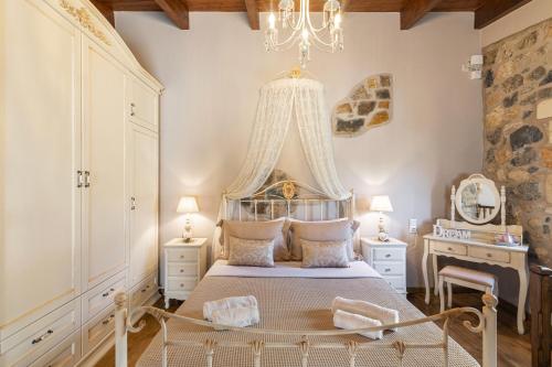 a bedroom with a bed and a chandelier at Terra Creta Hideaway in Heraklio Town