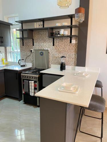 a kitchen with a stove and a counter top at 8693 Abba Place in Kampala