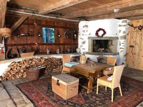 a dining room with a table and a fireplace at Forsthartl 7 Landhausurlaub in Steinbach