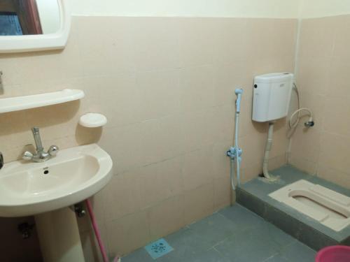 a bathroom with a sink and a toilet at Hunza Hilton Hotel Gilget Baltestan in Gilgit