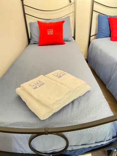 a bedroom with two beds with towels on them at NadSan Case Sparse in Camigliatello Silano