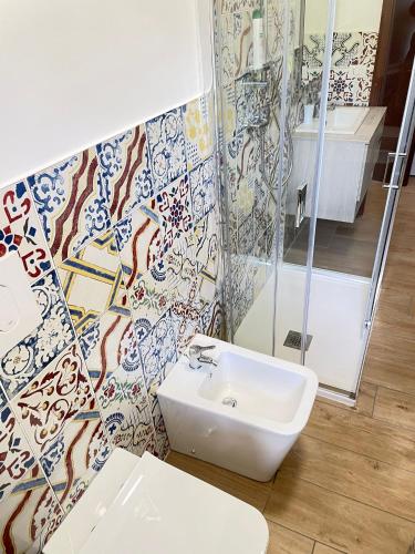 a bathroom with a sink and a glass shower at NadSan Case Sparse in Camigliatello Silano