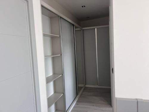 a walk in closet with white walls and shelves at Ulu Panorama Residence in Alanya