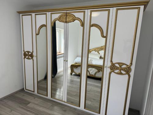 a closet with mirrored doors in a room with a bed at Schöne Wohnung in Satrup in Satrup