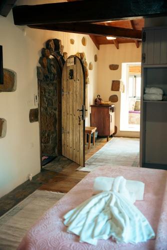a room with a bed and a wooden door at Areto Konak Otel in Dereköy