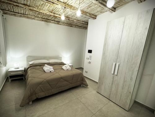 a bedroom with a bed with two towels on it at Ophelia - luxury house in Ioppolo Giancaxio