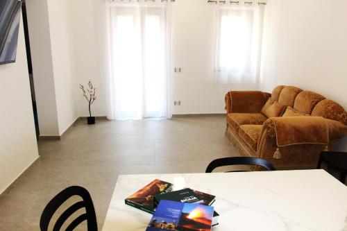 a living room with a table and a couch at Ophelia - luxury house in Ioppolo Giancaxio