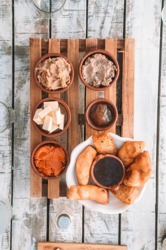 a table topped with different types of bread and dips at Eco Hotel Cueva del Gato in Benaoján