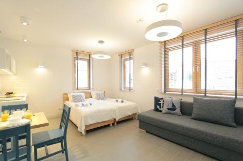 a bedroom with a bed and a couch at Dom Wakacyjny Solano in Ustka