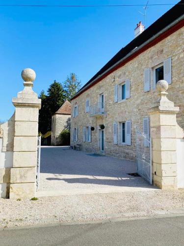 a brick building with a gate in front of it at Crisoline in Longwy-sur-le-Doubs