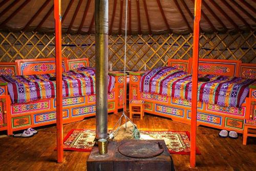 Nalayh的住宿－Dream Adventure Mongolia，蒙古包内一间设有三张床的客房